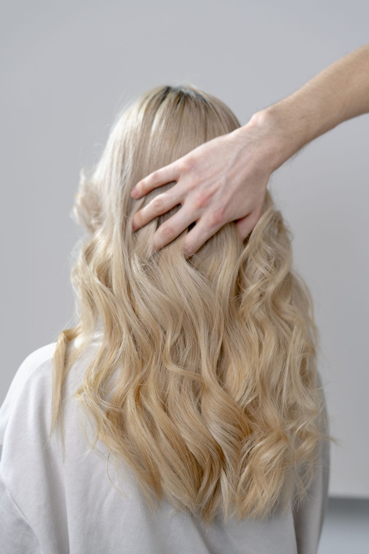 Long blonde hair finished in soft waves